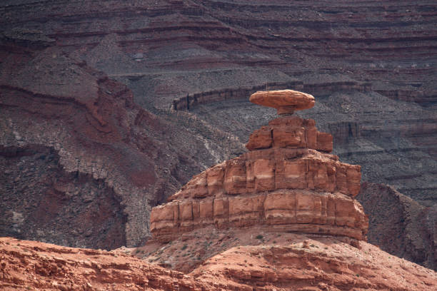 A climber takes in the view on Mexican Hat Rock in Mexican Hat, UT, United States