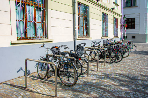 istock Bycicles parked and locked on the stands made for them 1218866983