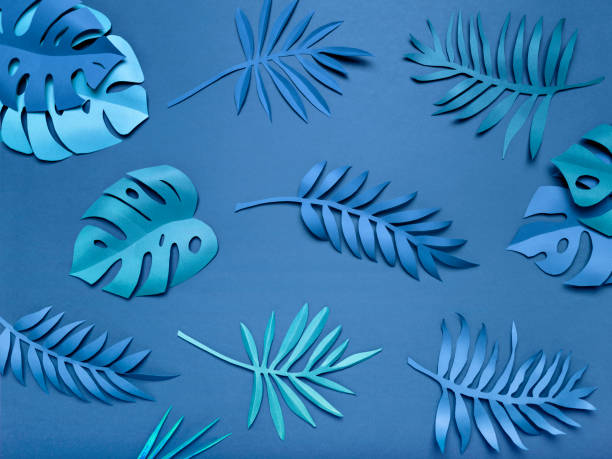 istock Bright blue tropical paper leaves. 1218867286