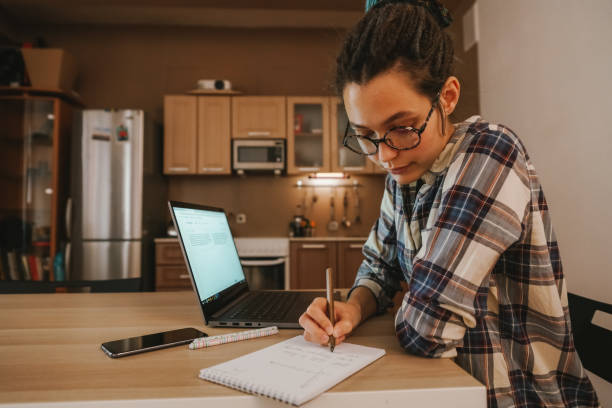 istock A girl with glasses is engaged in online training. 1218869151