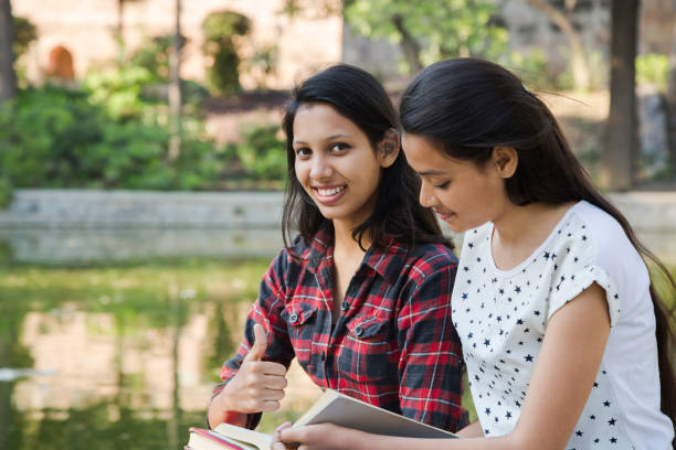 istock Happy students together in campus - stock photo 1218870186