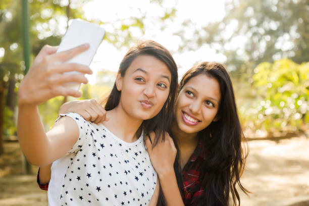 istock two young girls using smart phone stock photo 1218870847