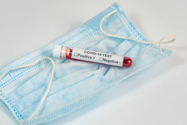 istock Covid-19 infection blood test sample and mask on white background 1218875358
