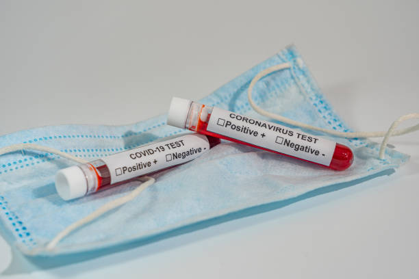 istock Coronavirus blood test sample and medical mask on white background 1218875364