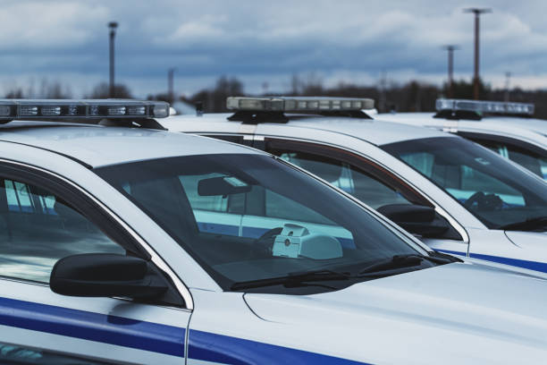 Police Cars Police cars in parking lot. police station canada stock pictures, royalty-free photos & images
