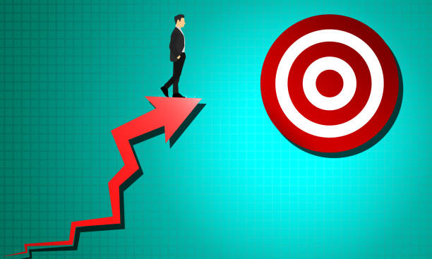 istock Businessman standing on red arrow target for success 1218880646
