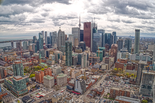 Toronto, Canada - May 13, 2023: The CN Tower stands tall against a backdrop of modern city buildings. The downtown is a tourist attraction