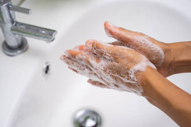 istock washing hand with hand wash foam 1218887193
