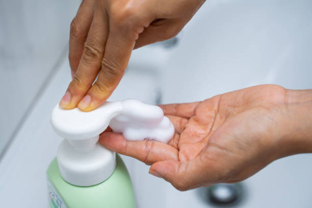 istock washing hand with hand wash foam 1218887194