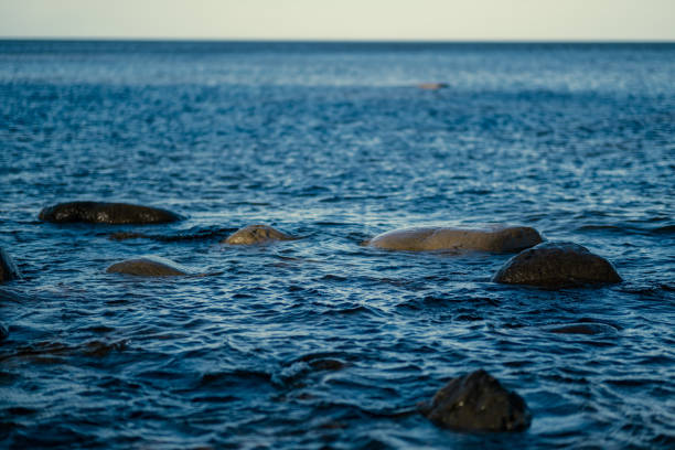 istock sunny beach with blue water and large rocks in the sand 1218893579