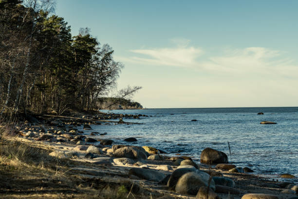 istock sunny beach with blue water and large rocks in the sand 1218893584