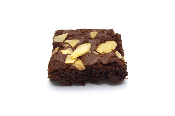 istock Chocolate brownies with sliced almond nuts toppings isolated on white background. 1218898627