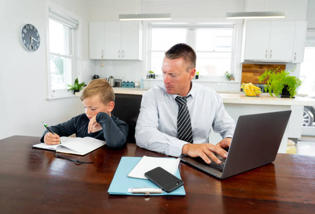 istock COVID-19 Working from home. Stressed parent trying to cope with remote work and homeschooling. Coronavirus pandemic forces shutdowns, quarantine, online learning and Work. 1218898979