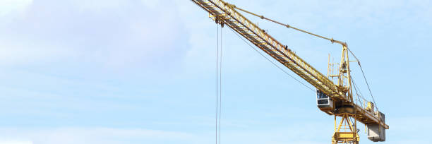 istock Construction crane works on site, street view 1218899557