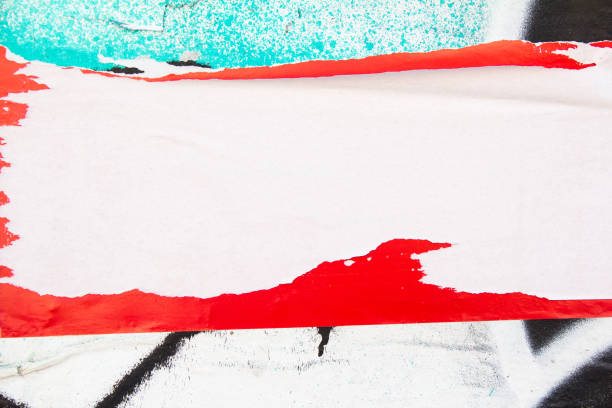 Torn paper placard on dirty urban wall with peeling paint texture background. Copy space for text.