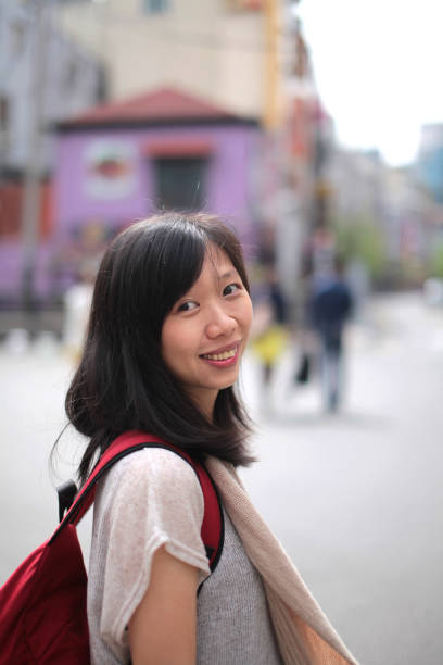 istock Young Asian Girl Walking On Street With Backpack 1218905220