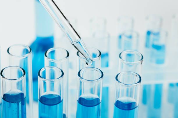 istock Laboratory glassware with a dropper dripping liquid into a test tube. scientific laboratory test tubes, laboratory equipment 1218907736