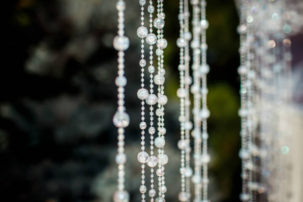 White curtains of hanging lines of crystals that sparkle, shimmer and shine in the sun. Copy space. Wedding frame