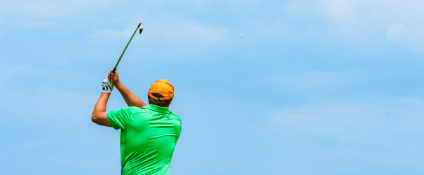 istock Close up Golfer is driving golf ball to green course 1218909891