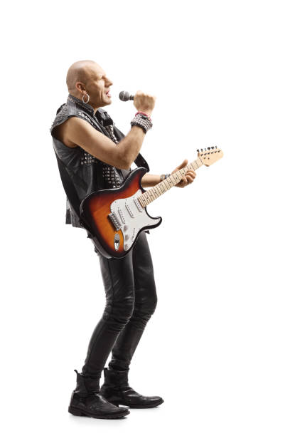 istock Male rock star with a microphone and an electric guitar 1218910046