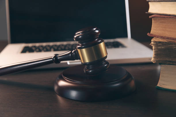 istock Gavel with books and scales on brown background 1218910374