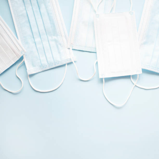 istock Medical masks on a light blue background. 1218911854