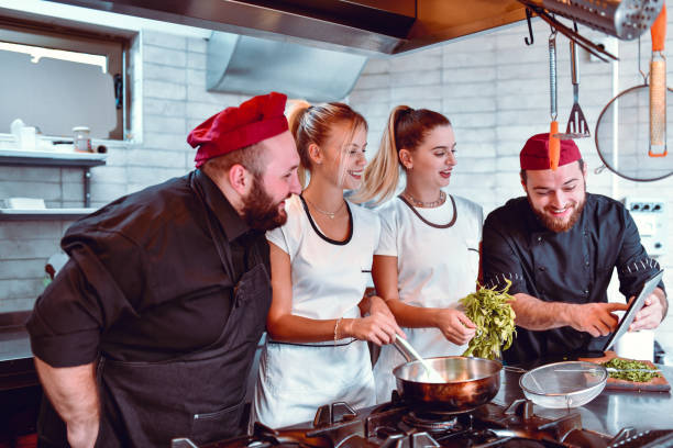istock Kitchen Team Watching New Recipe On Digital Tablet 1218912082