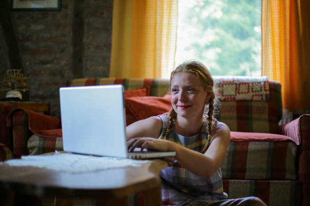 istock Young woman using laptop at home 1218912502