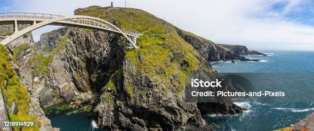 Panoramic Picture Of Pedastrian Bridge To Mizen Head Lighthouse In South Ireland During Daytime Stock Photo - Download Image Now
