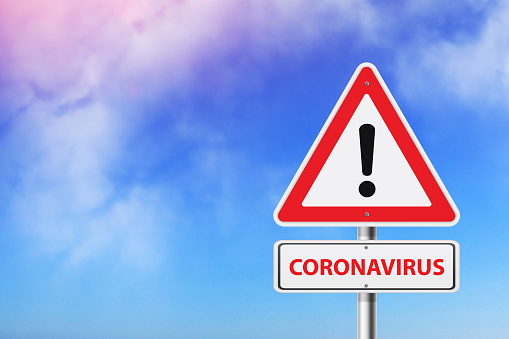 Coronavirus, road sign on sky background