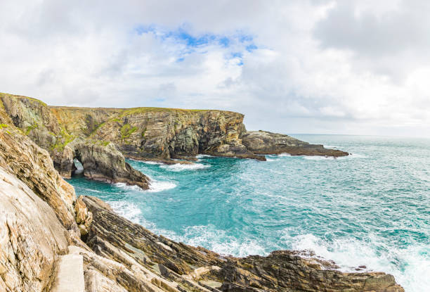 Rough cliff line at Mizen head lighthouse in southern west Ireland during daytime Rough cliff line at Mizen head lighthouse in southern west Ireland mizen head stock pictures, royalty-free photos & images