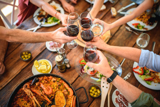 Toasting with Red Wine and Water Before Start of Midday Meal
