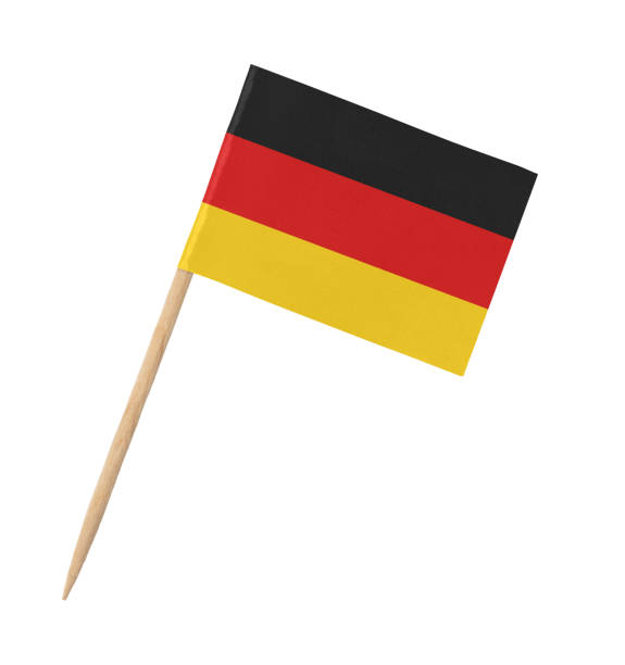 istock Small paper German flag on wooden stick, isolated on white 1218920432