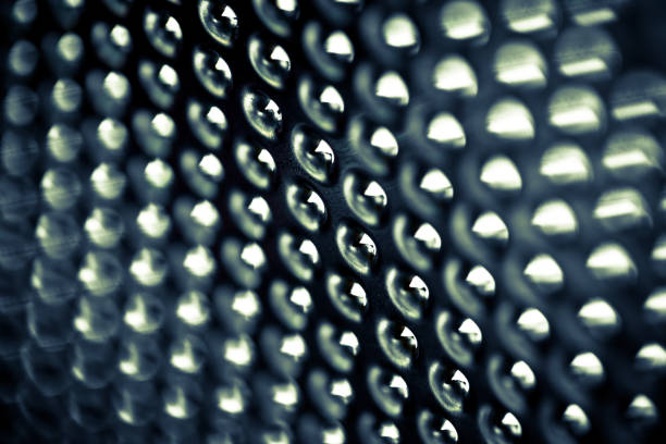 Extreme close up macro color image depicting an abstract view of a cheese grater. Selective focus with copy space.