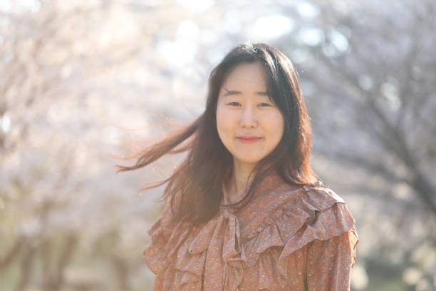 istock Asian woman with cherry blossom 1218922672