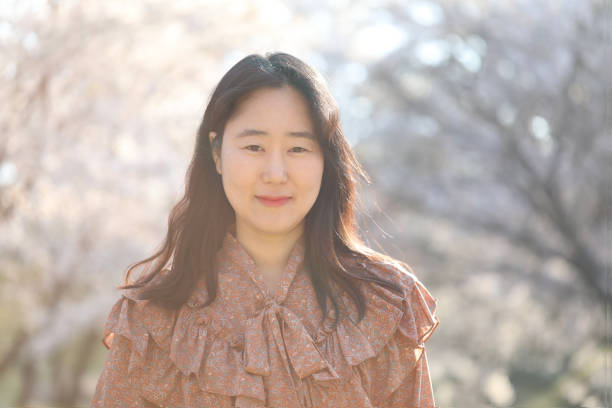 istock Asian woman with cherry blossom 1218922817