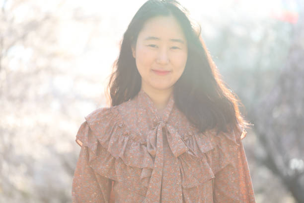 istock Asian woman with cherry blossom 1218922994