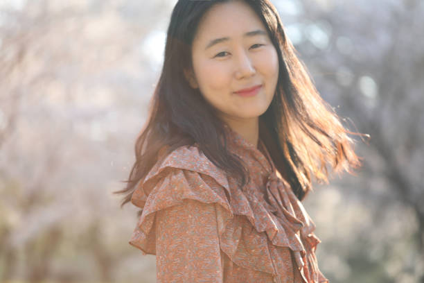 istock Asian woman with cherry blossom 1218924408