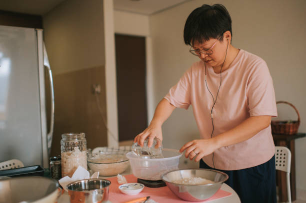 istock an asian chinese stay home mother preparing dough while using phone online checking for for recipe and guidance online class 1218924772