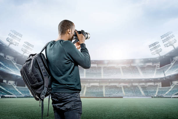 TV camera at the stadium, broadcasting during a football, soccer match
