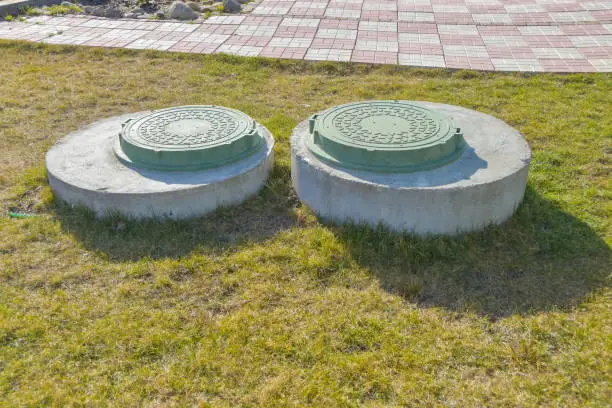 Photo of manhole sewer cleaning system on the ground on a Sunny spring day