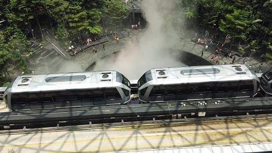 Singapore - Aug 8, 2019: top view of the skytrain on railway, transporting people through Jewel under Rain Vortex, indoor waterfall, to terminal Changi International Airport.