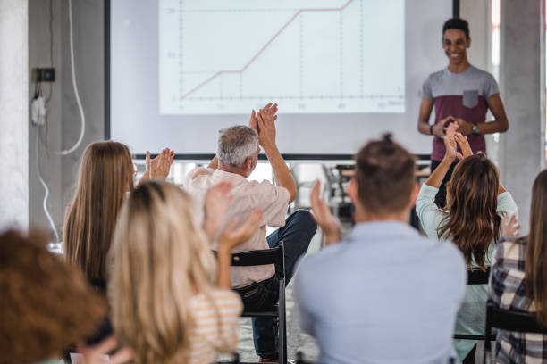 istock Back view of people applauding on a training class. 1218929718