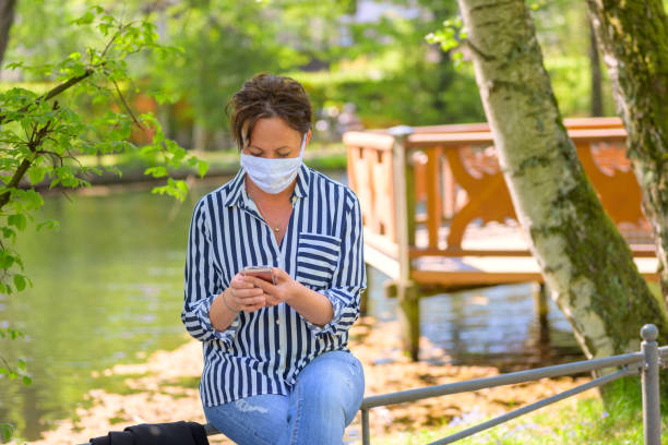 Woman relaxing with a mobile phone in a park