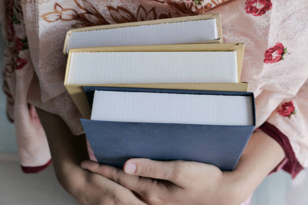 istock Young student holding books in her hands 1218933379