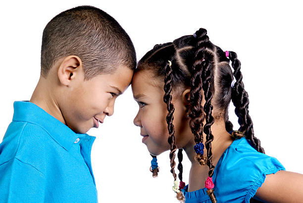 Siblings staring at each other. (White background)