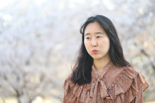 istock Asian woman with cherry blossom 1218936340