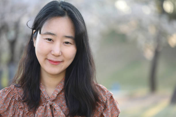 istock Asian woman with cherry blossom 1218936415