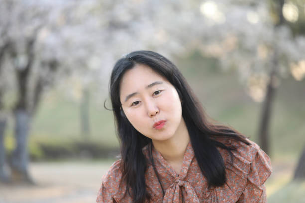 istock Asian woman with cherry blossom 1218936491