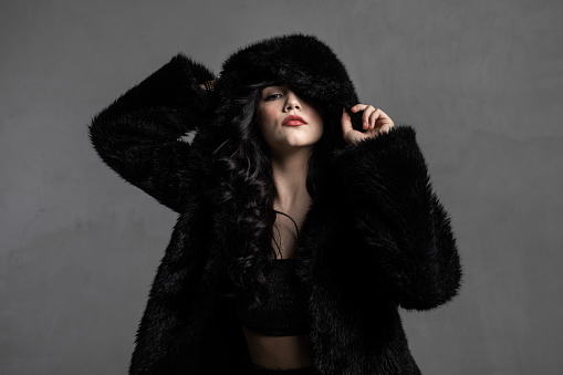 Beautiful woman wearing fur hood.